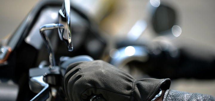 Gloved hand on a motorcycle grip
